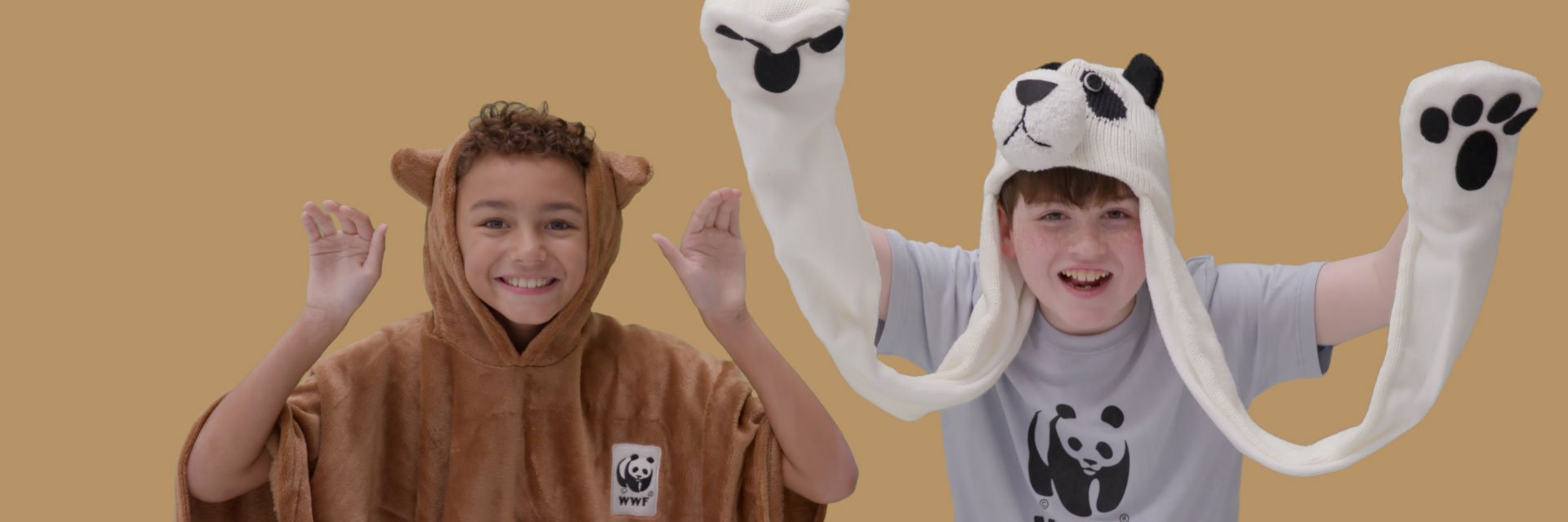 children wearing brown bear poncho and panda hat